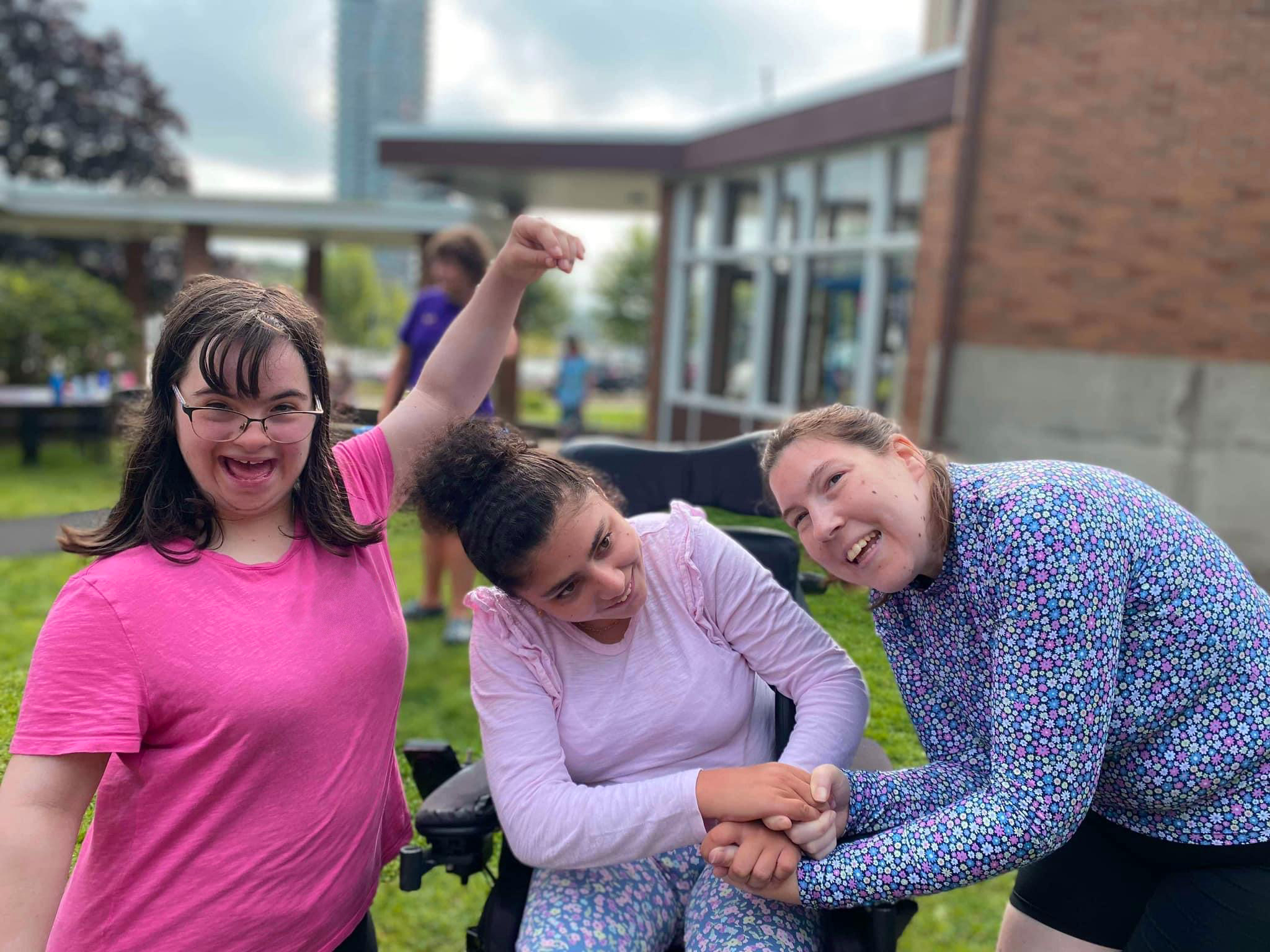 three members of day camp are outside, enjoying each others company outside