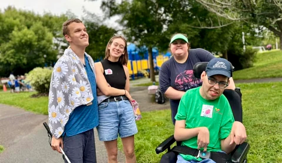 group of 4 people walking along a trail in the park